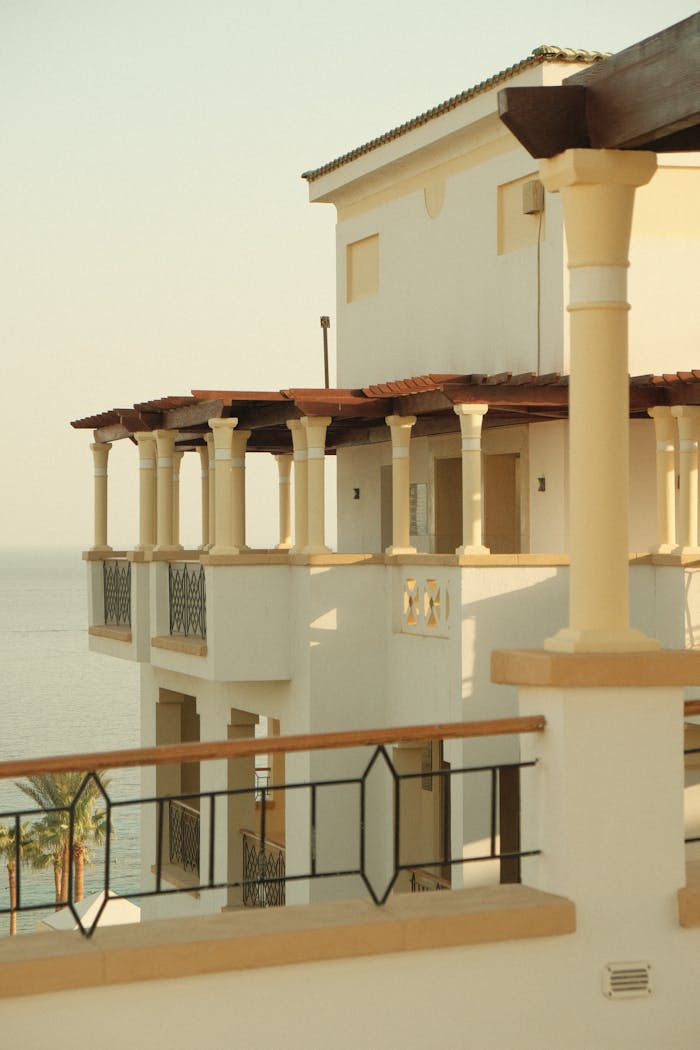 Elegant Mediterranean architecture with sea view, captured at sunset.